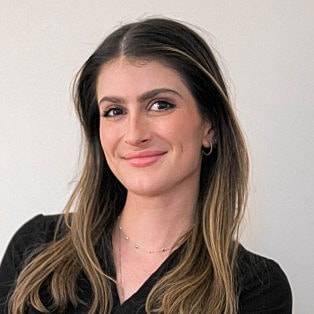 Smiling woman with long hair and earrings.