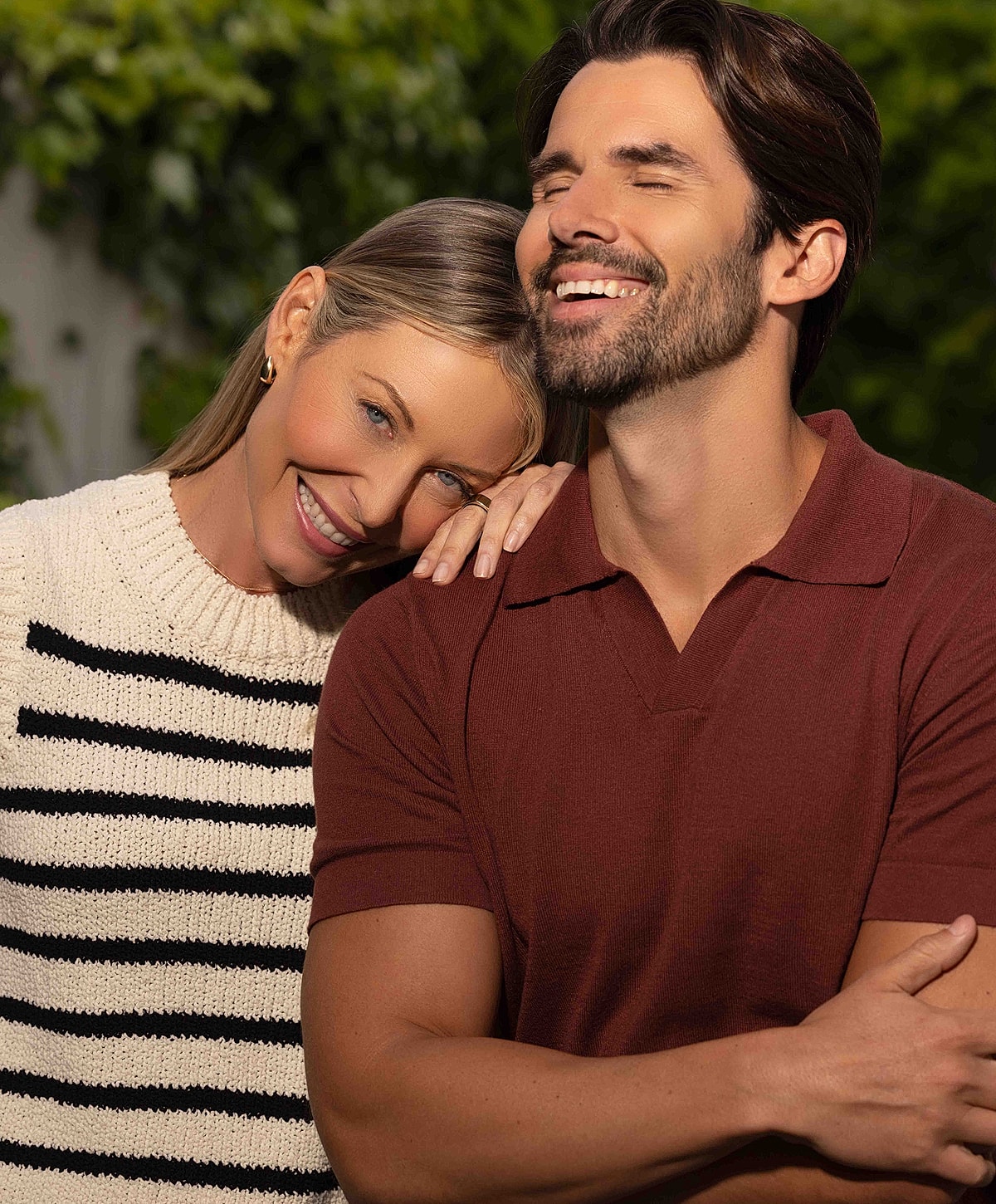 Smiling woman with long, wavy hair.