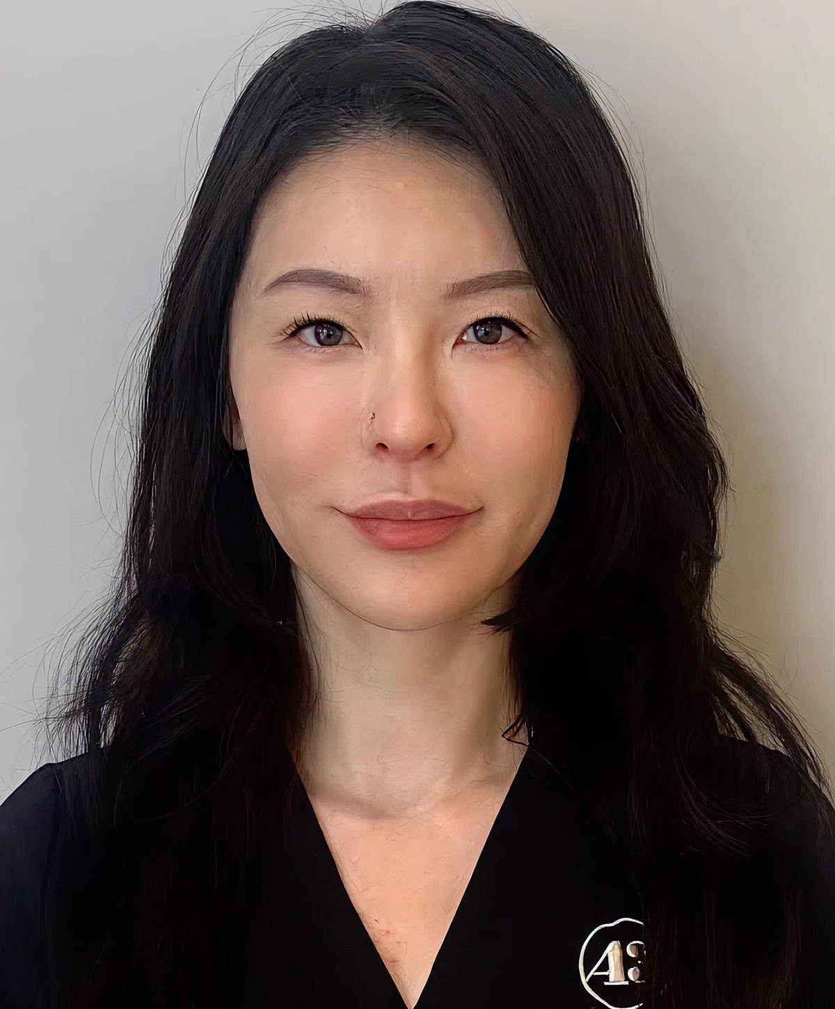 Professional woman with long dark hair.