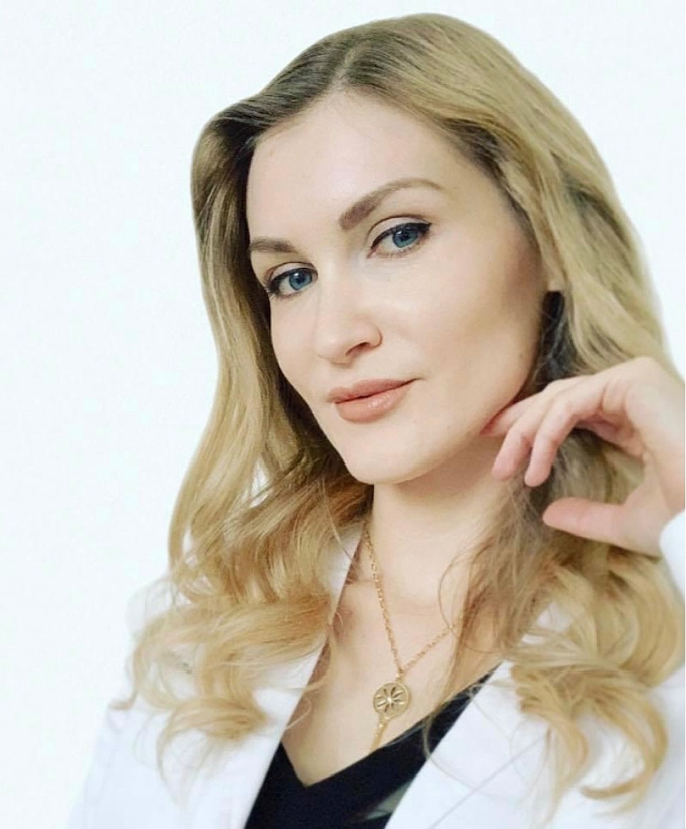 Woman with long hair in professional attire.