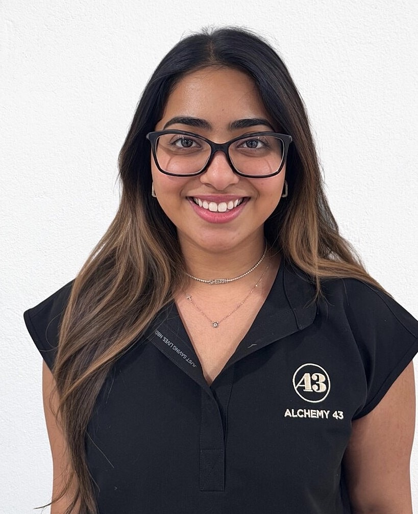Smiling woman wearing glasses and black top.