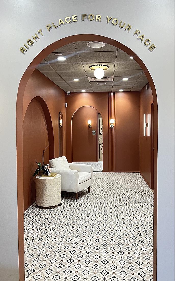 Chic hallway with unique decor and seating area.