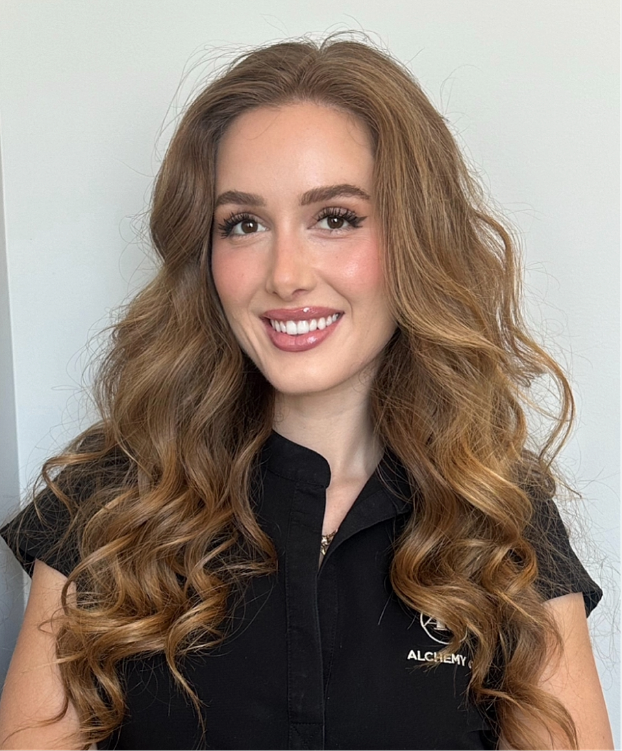 Smiling woman with wavy hair and professional attire