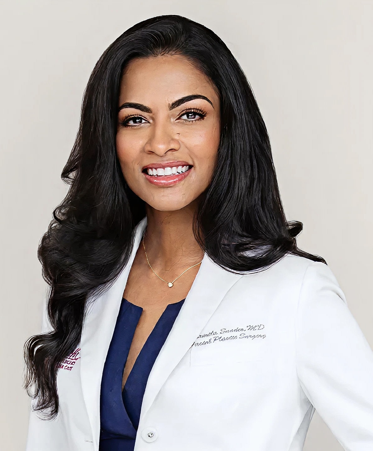 Smiling doctor in white coat with long hair