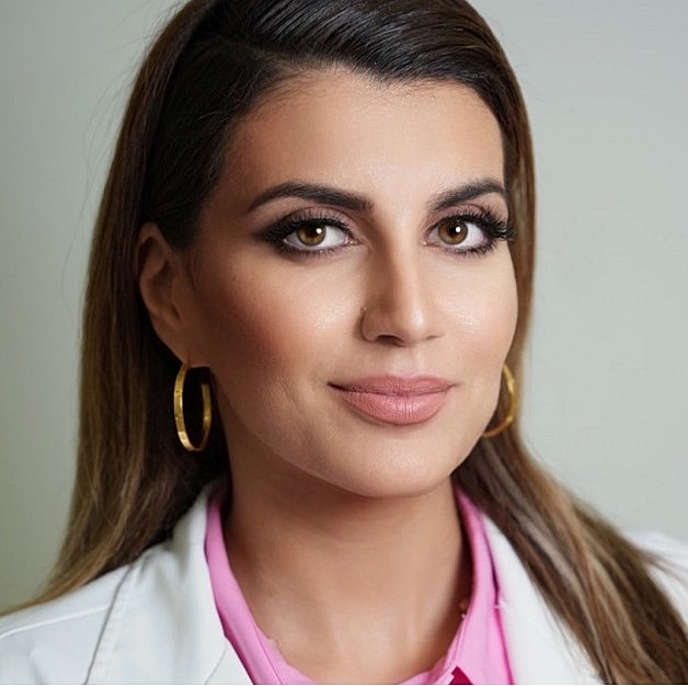 Professional woman with long hair and earrings.