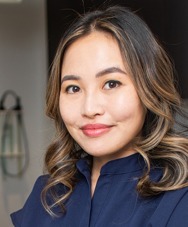 Professional woman with long hair and earrings.